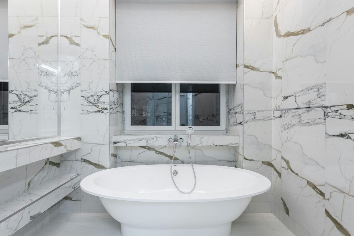 Gold accent marble luxury bathroom by ELSO Contracting