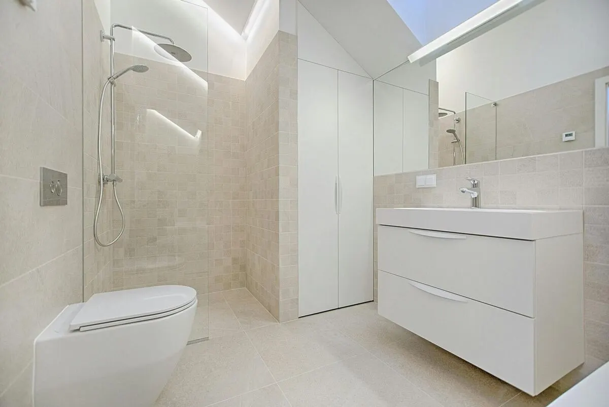 Minimalist beige tile walk in shower with curbless entry white floating vanity