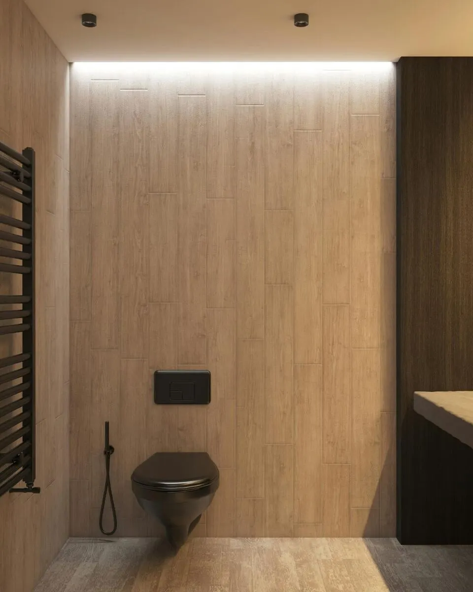 Minimalist wood plank bathroom with black fixtures and LED cove lighting