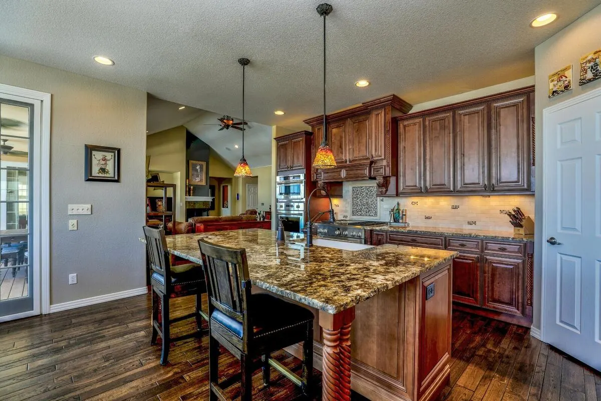 Open concept kitchen with quartz counters and custom cabinetry